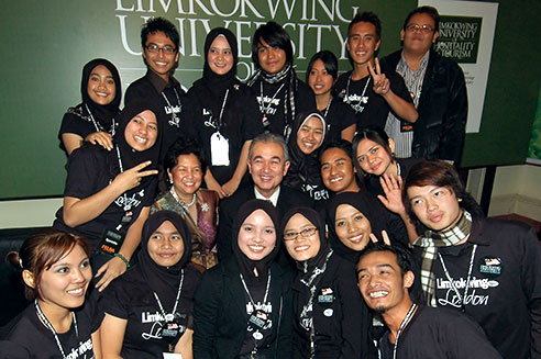 Tun Abdullah and wife with Limkokwing London students.
